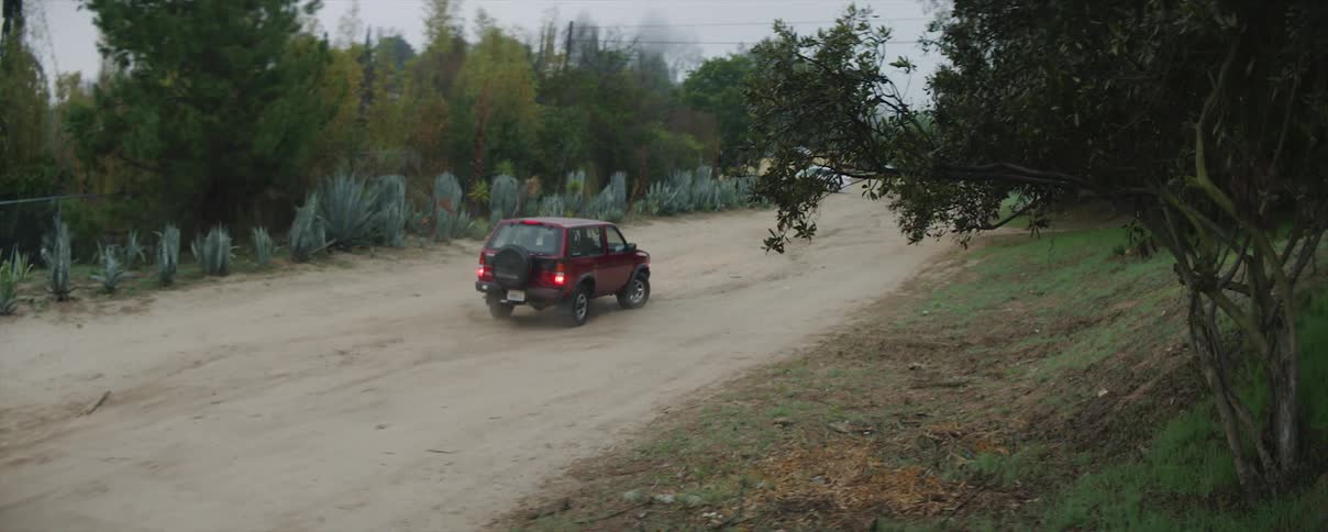 A vehicle comes to an abrupt stop on a dirt road