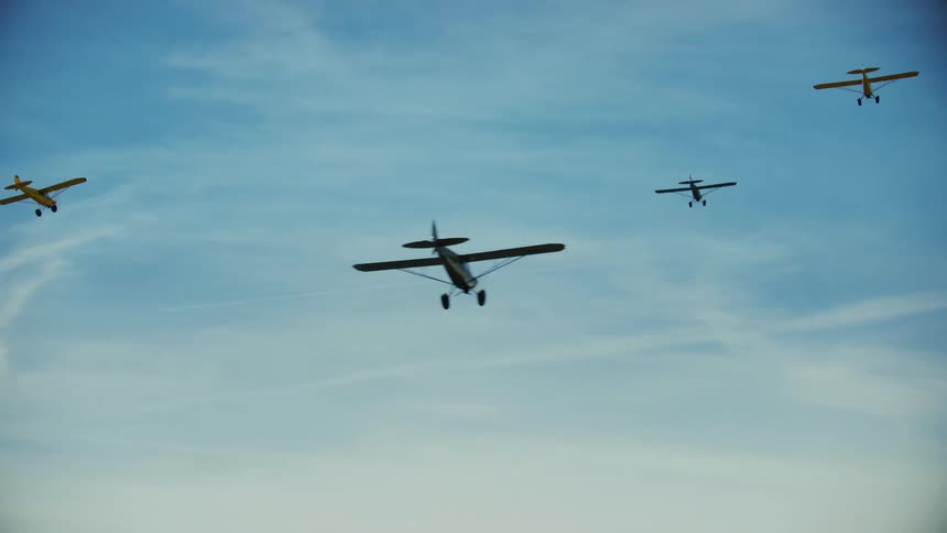 Backcountry airplanes fly above the camera showing the vast sky above Idaho