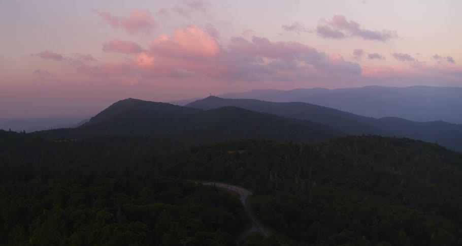 Aerial view of mountainous area with pink sky at dusk