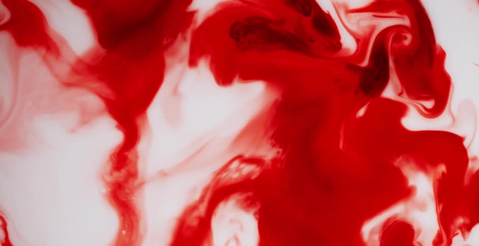 Red liquid is moving outward and into the white area as the colors blend