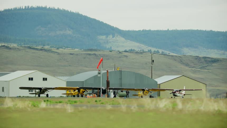 Five small airplanes receive fuel at a small airport on the way into the backcountry
