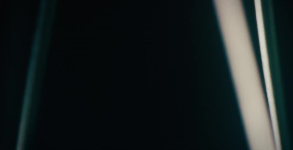 Hanging straps of object rotate against a dark background