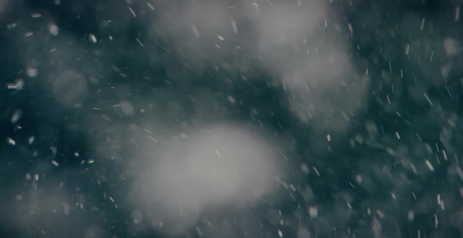 Snow swirls and blows around as it falls from the sky