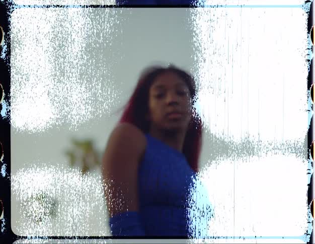 Woman with red hair and blue top dances to music