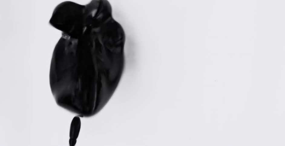 Graphic special effects of a vibrating blob of black liquid forming a loose star shape in front of a white background