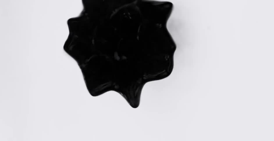 A black blob dances around and forms into different shapes before coming to a stop