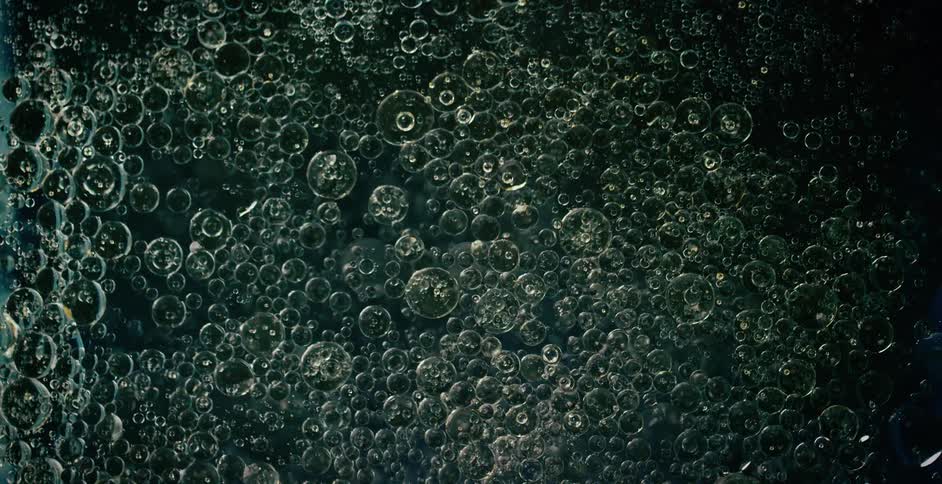 Bubbles are reflecting light as they float and move in liquid
