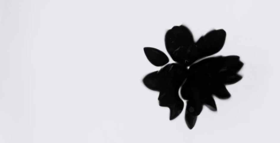 Black blobs bouncing around forming shapes as they splat