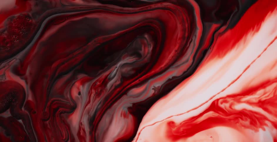 Liquid red swirls and blends with white in one area and black in another area