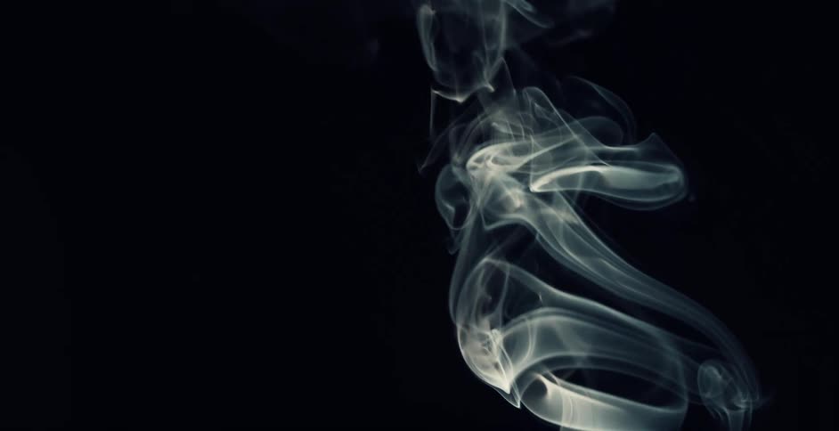 White smoke rising against a black background