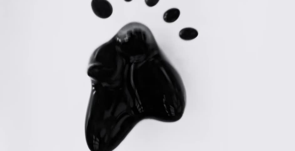 Graphic special effects of a blob of black liquid forming a loose star shape before melting