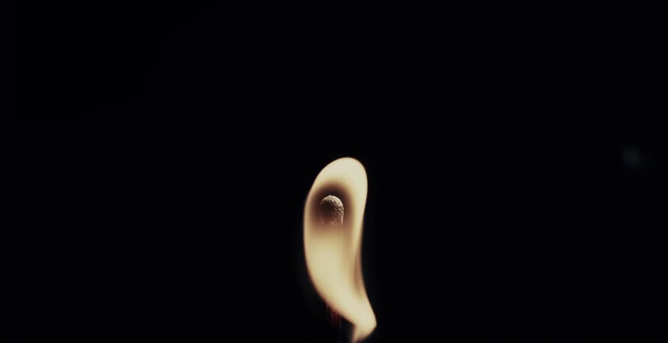 A match burns and the flame moves in the wind until it goes out
