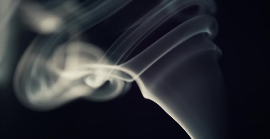 Smoke moves in a swirl pattern against a black background
