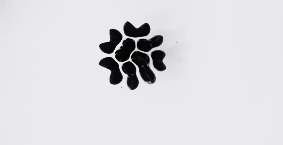 Black mass continuously spits into smaller and smaller globs before coming together to create flatened shape