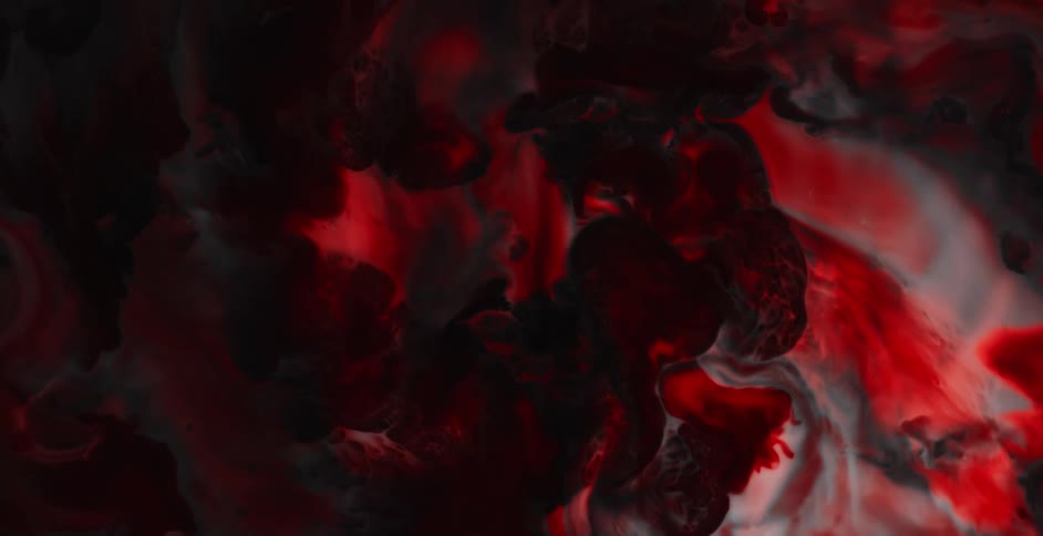 Twisting footage of a dark mix of black and red liquid ink mixing in swirls