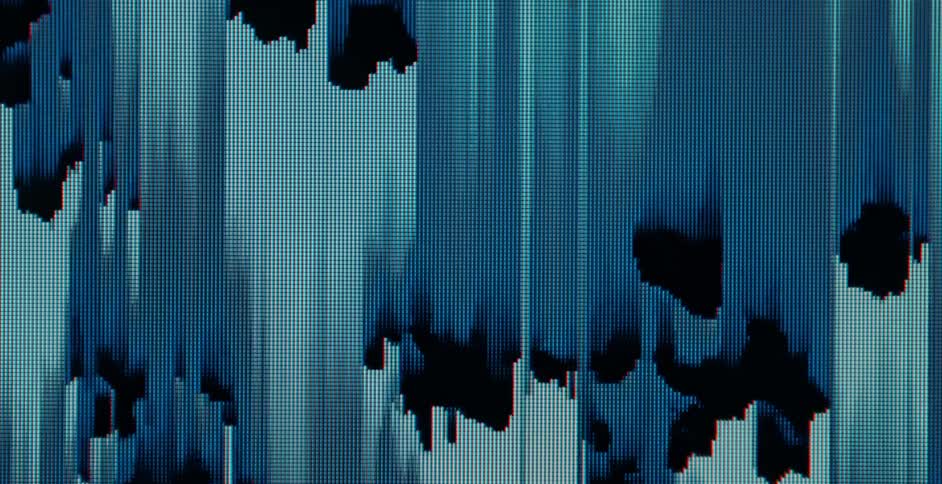 Digital bars in shades of blue move across the screen in a glitch way