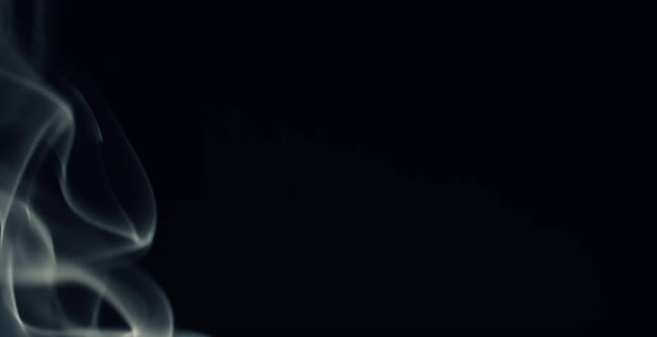 White smoke rising against a black background