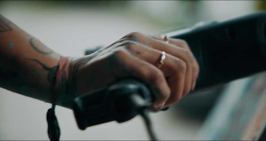 An artist using an air gun on her painted canvas