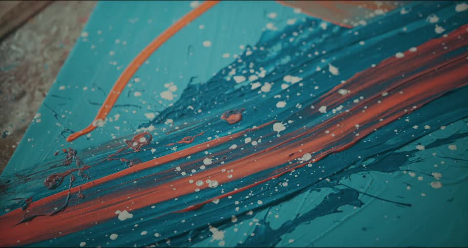 Close up of a modern abstract art painting on canvas laying in the floor of an art studio