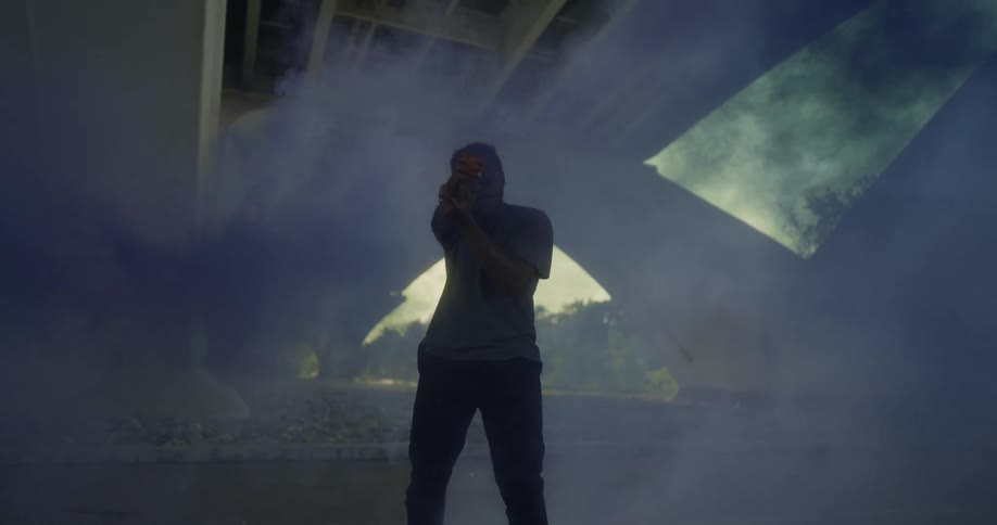 A man uses smoke and arm movements to create an illusion