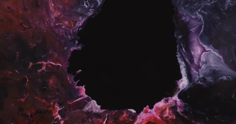 An opening is in the middle of a purple and red space nebula