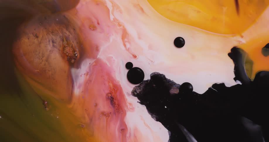 Colorful liquid flows slowly and forms patterns