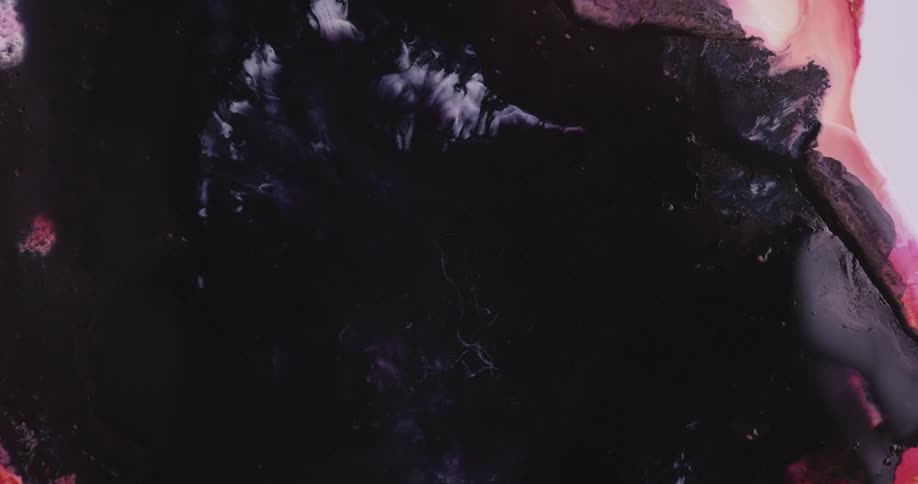 Intense dark black liquid ink flowing and pushing pink ink out of the frame on a white background