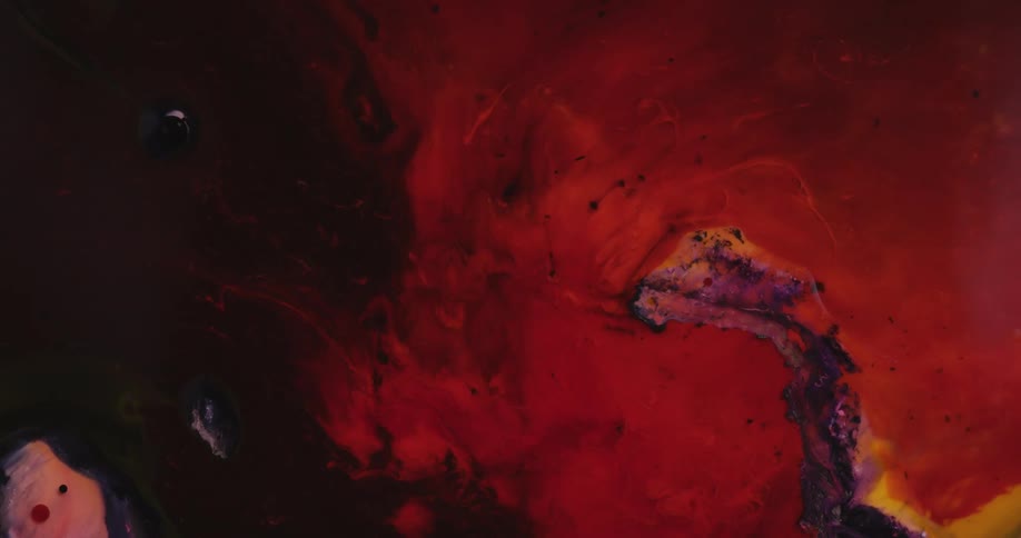 An organic movement of hot red liquid colors are moving across the darkness like a burning invasion