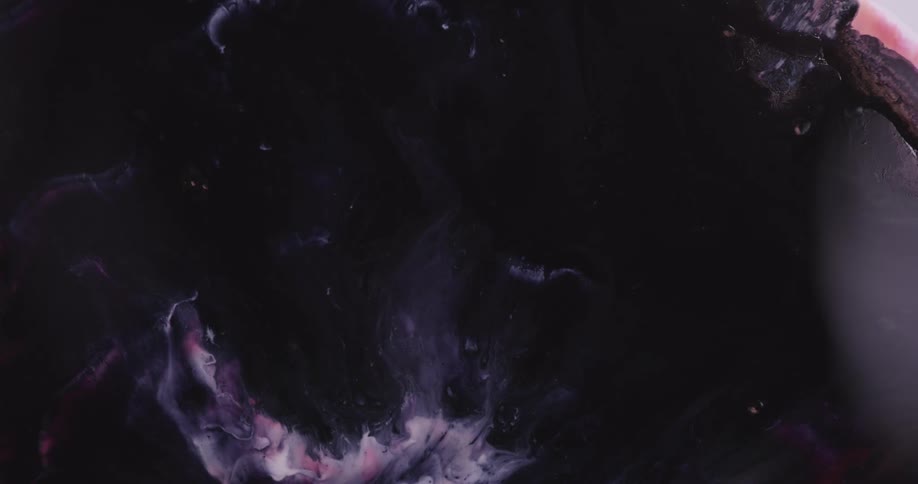 Intense dark liquid ink spreading in waves over a white background