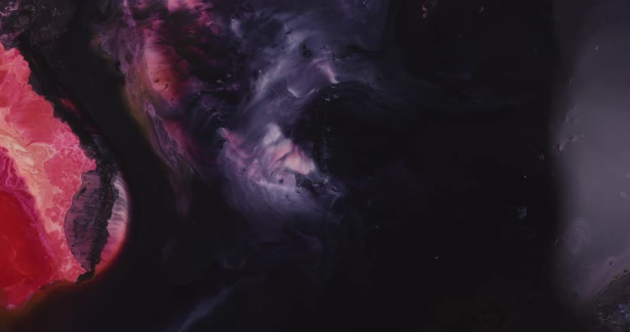 Black fluid spreads against a red and gray background