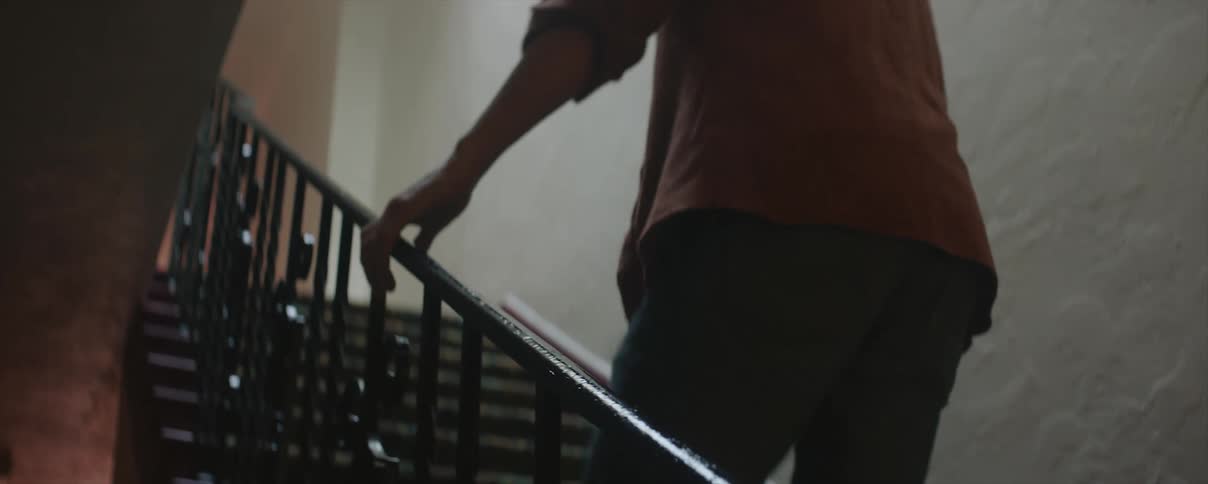 Man climbing up a staircase to the first floor of a house