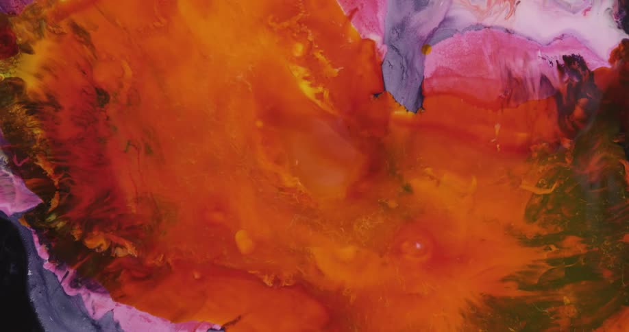 Orange and yellow paint spreads across a base of pink and purple paint to form an abstract pattern