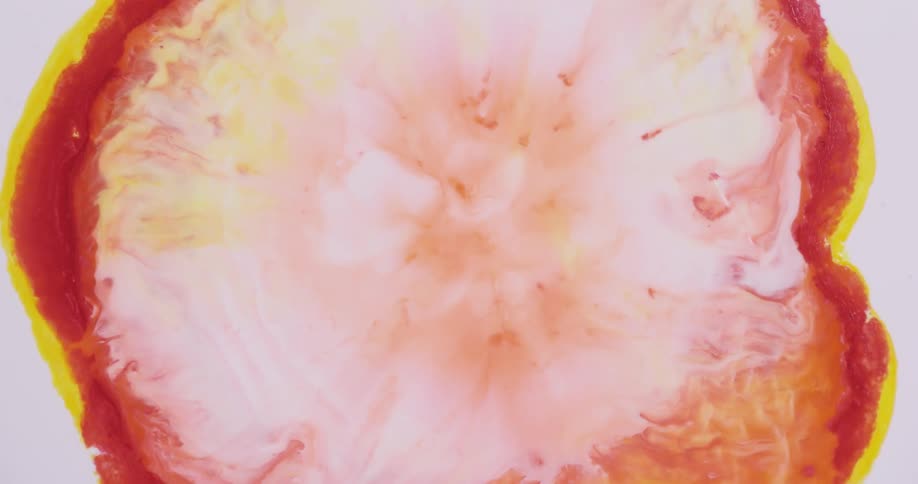 A pink and white blob of color blends as it grows inside a red and yellow outline rapidly covering the white background