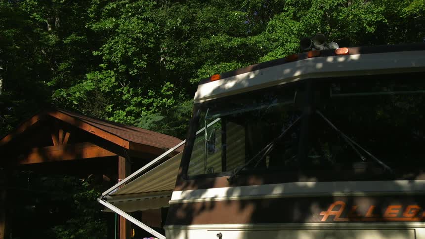 An rv parked under some trees
