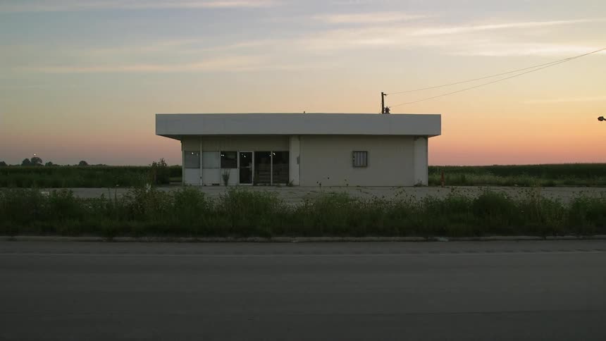 A square white building at sunset