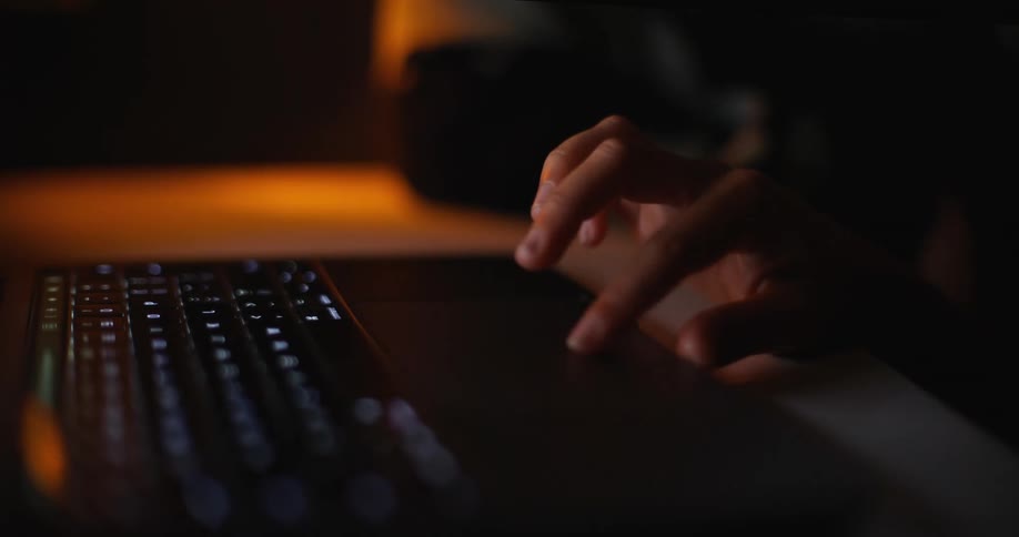 A persons fingers are on the touchpad of a laptop computer