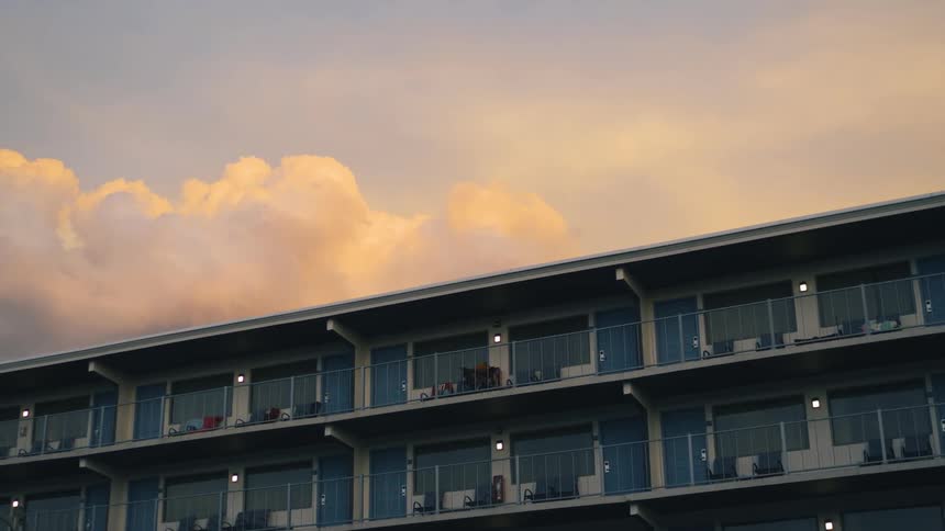 Red tinted clouds flows slowly over hotel complex