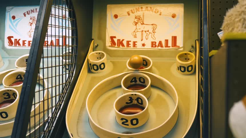 A ball is tossed in a game of skee ball