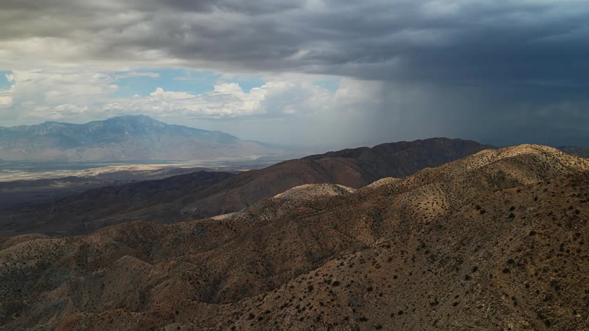 Aerial view of clouds floating over mountain ranges