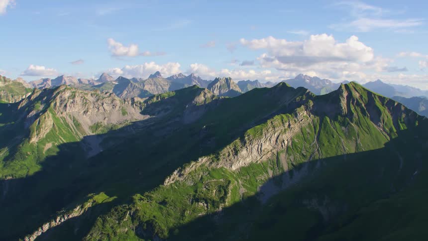 Aerial view of the rugged slopes of a mountain peak at morning