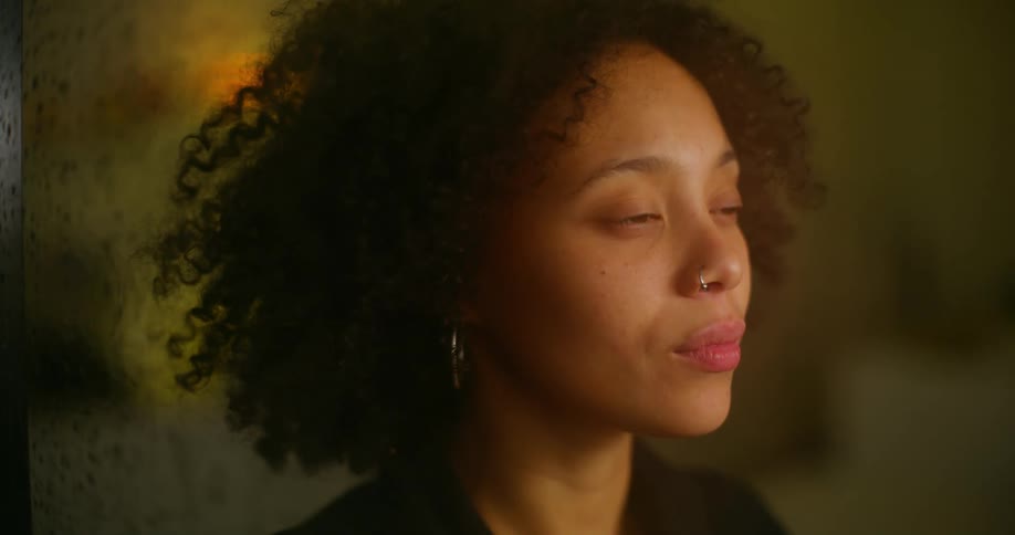 A younger black woman is relaxing in the evening
