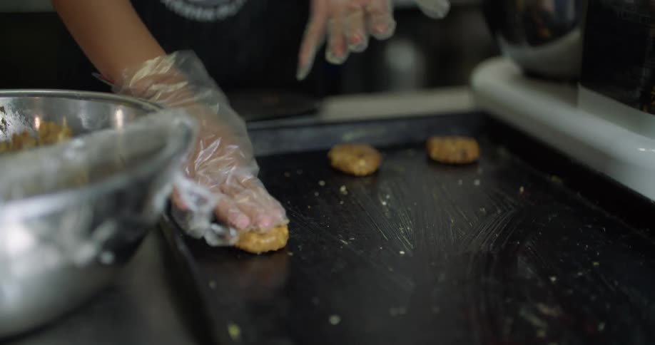 Person places cookie dough onto a cookie sheet