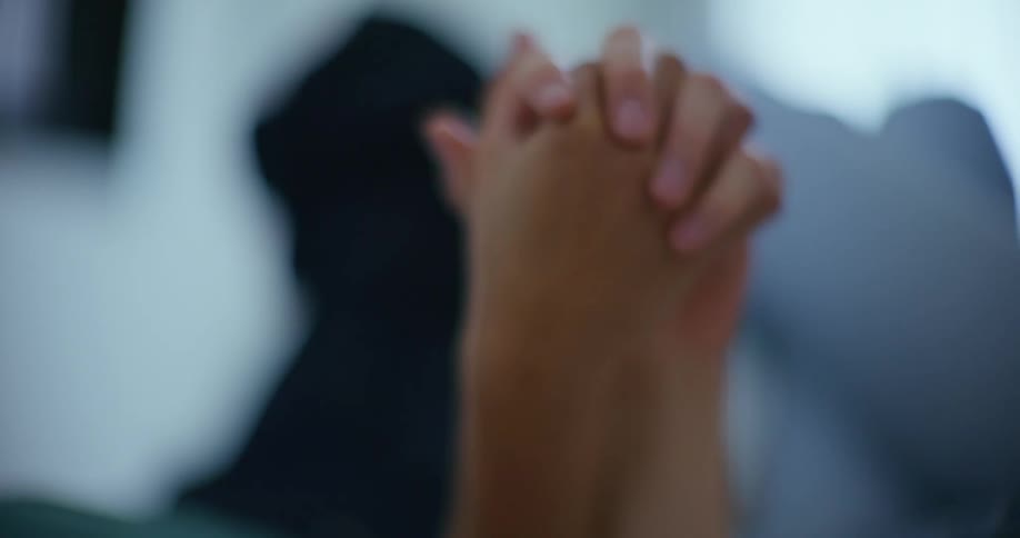 A close up of two women holding hands