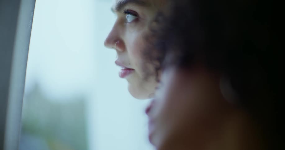 Two women are gazing at a window during the daytime