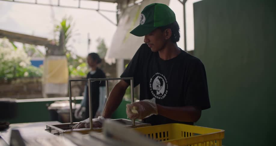 A man making food in an outdoor restaurant