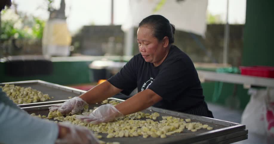 Two workers marking food at a factory