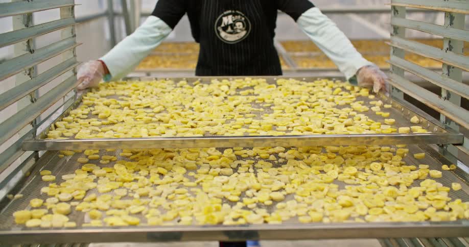 A view of a person moving trays of food