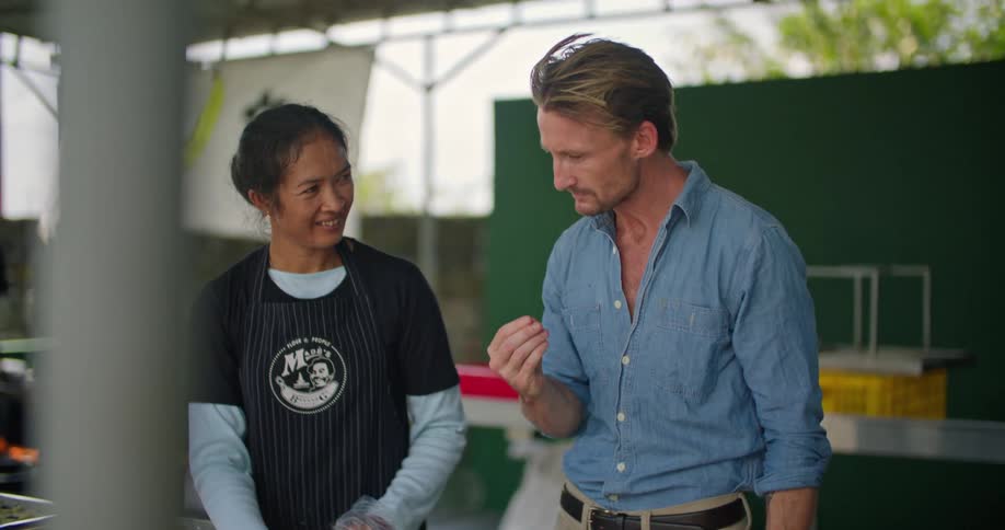 Man and woman are preparing food outdoors together