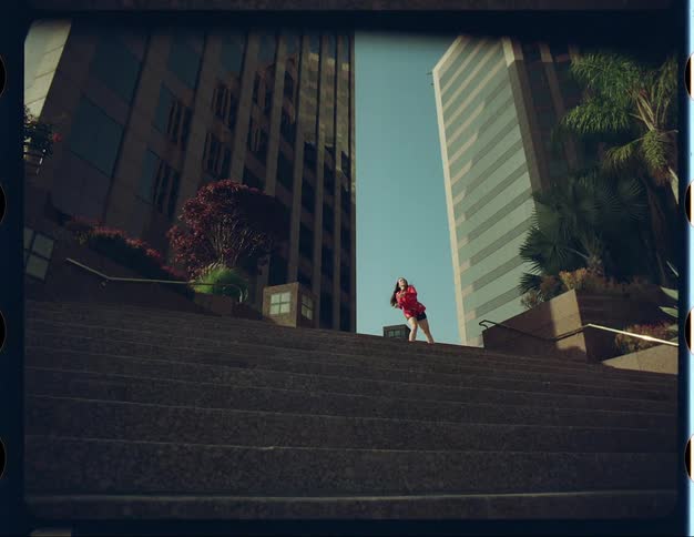 A woman dances on top of a downtown staircase