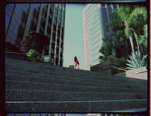 A woman is dancing on the stairs